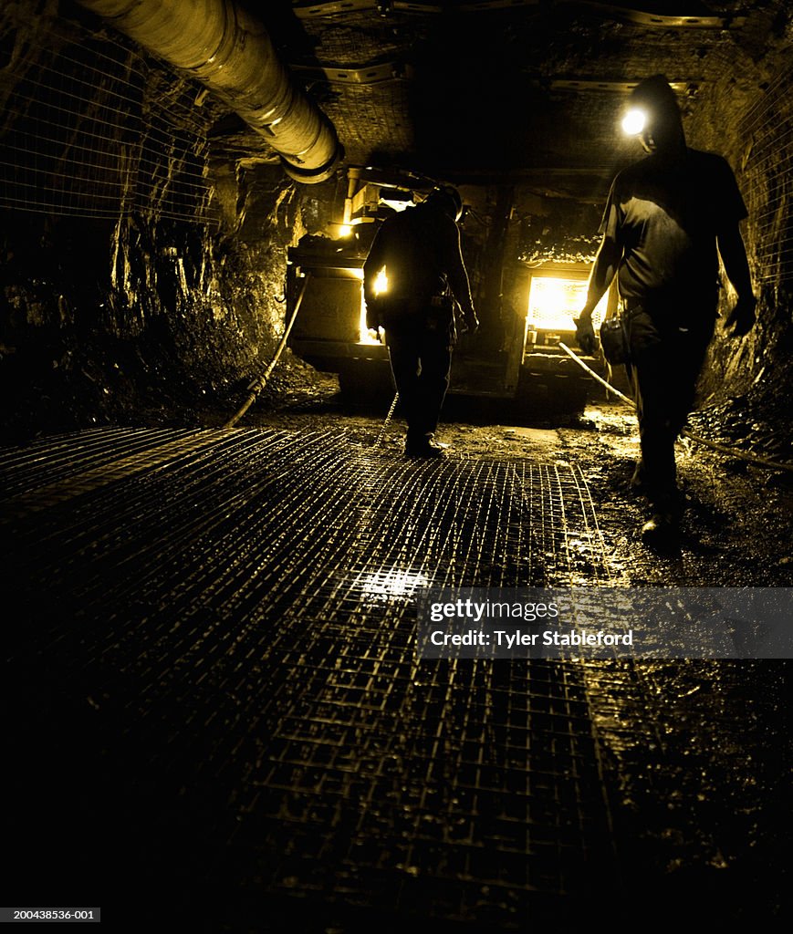 Two coal miners in mine shaft (yellow tone)