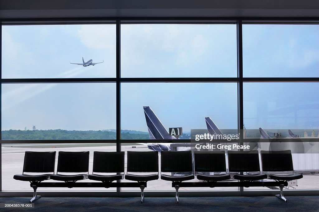 Airport waiting area, airplane taking off