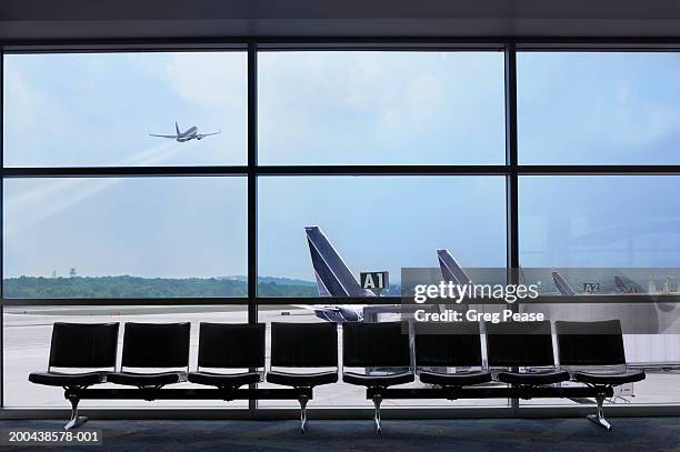 airport waiting area, airplane taking off - lounge chair bildbanksfoton och bilder