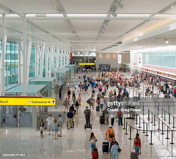 passengers in airport terminal, elevated view - luchthaventerminal stockfoto's en -beelden