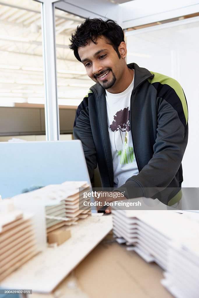 Young designer working with models in studio