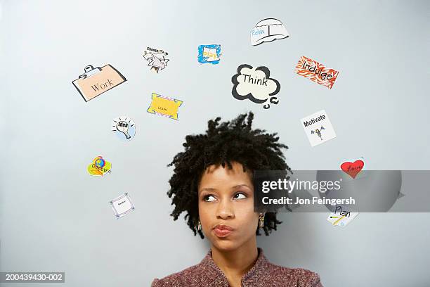 young businesswoman under arc of signs - confused woman stockfoto's en -beelden