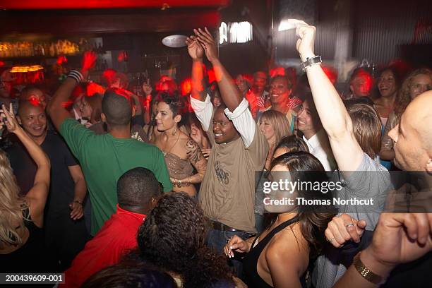 group of adults dancing in nightclub (blurred motion) - dance floor stock pictures, royalty-free photos & images