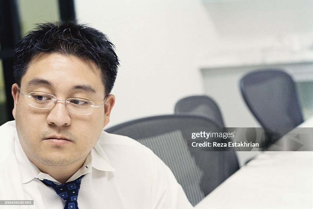 Young businessman sitting in conference room