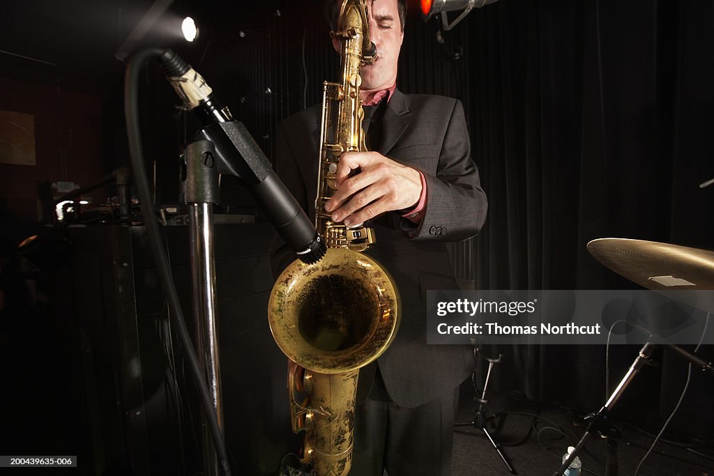 Man playing saxophone, eyes closed