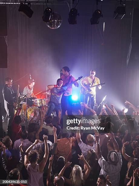 adults watching band perform in nightclub, elevated view - guitar stage stock pictures, royalty-free photos & images