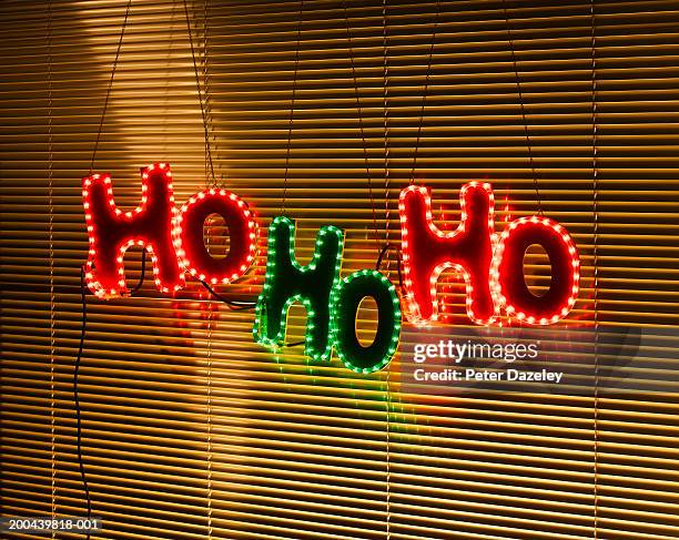 illuminated 'ho ho ho' decoration behind blind on window - alphabet neon photos et images de collection