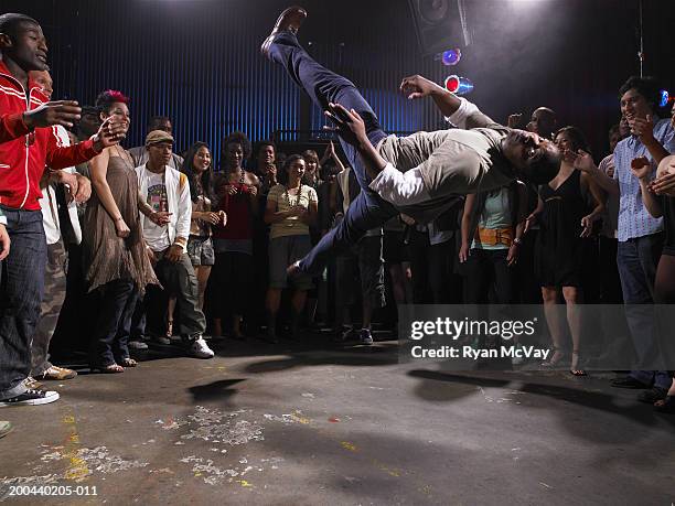 group of adults watching man breakdance in club - street dance stock pictures, royalty-free photos & images