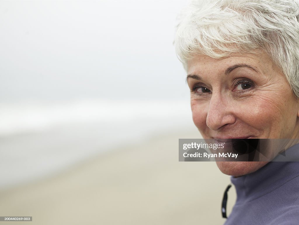 Mature woman on beach, smiling