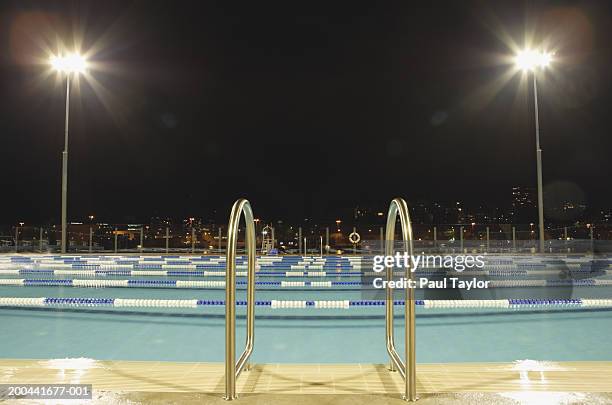 swimming pool at night - swimming pool night stock pictures, royalty-free photos & images