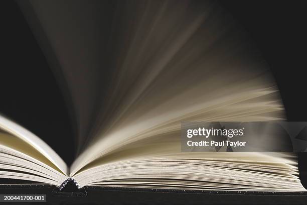 open book with pages being flipped (blurred motion) - literature fotografías e imágenes de stock