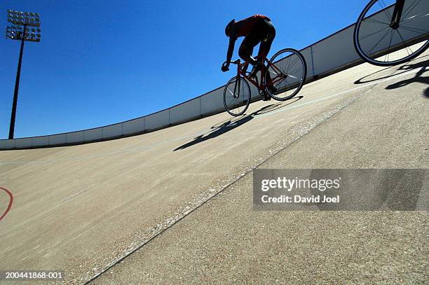 cyclists on velodrome track, low angle view - track cycling - fotografias e filmes do acervo