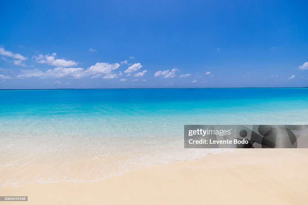 Tropical beach sea sand sky and summer day shore beach front coastline landscape. Empty sea and beach background with copy space. Sunshine relaxation tranquility summer scene