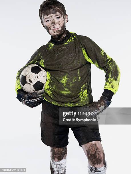 boy (11-13) soccer goalkeeper covered in mud, portrait - people covered in mud stock pictures, royalty-free photos & images