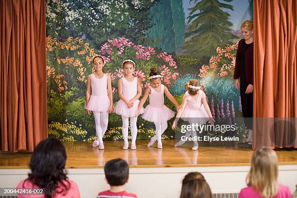 teacher watching four ballerinas (5-9) perform on stage - girl stage stock-fotos und bilder