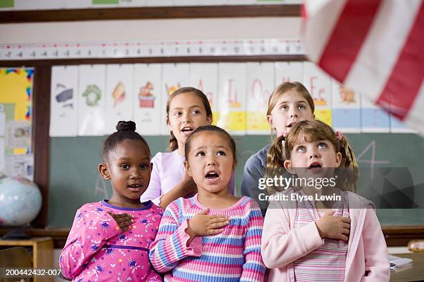 Girls Singing With Hands On Chests Closeup High-Res Stock Photo