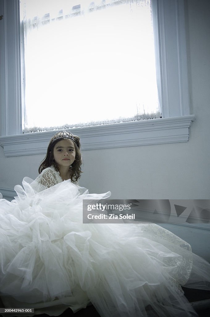 Girl (4-6) wearing bridal gown and tiara, portrait