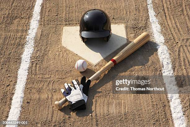 baseball, bat, batting gloves and baseball helmet at home plate - baseball helmet ストックフォトと画像