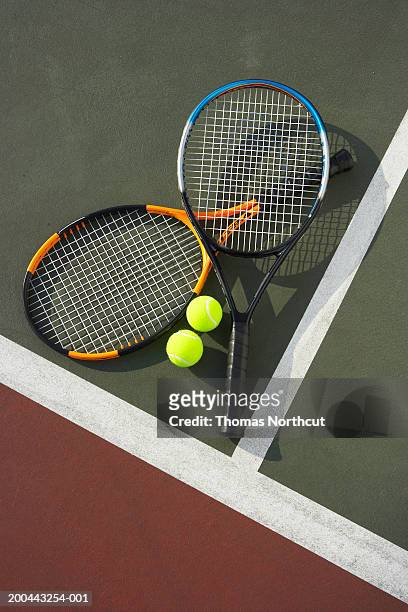 two tennis rackets and tennis balls on tennis court, overhead view - racket stock pictures, royalty-free photos & images