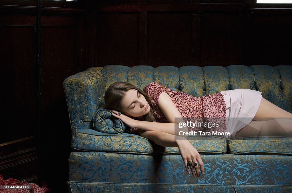 Young woman sleeping on sofa