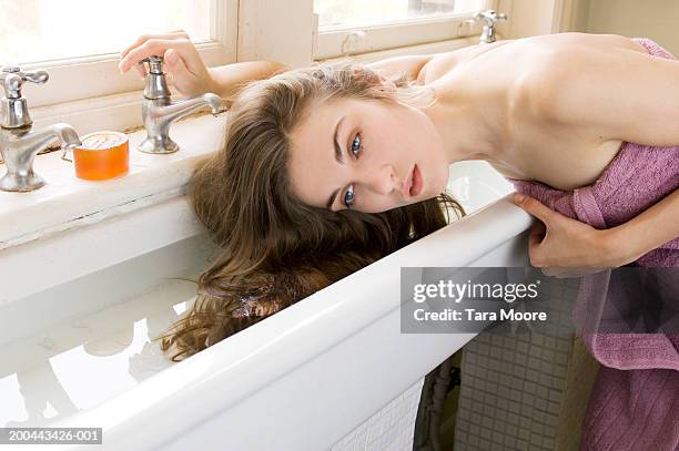 young woman wearing towel, washing hair in sink - haar wassen stockfoto's en -beelden