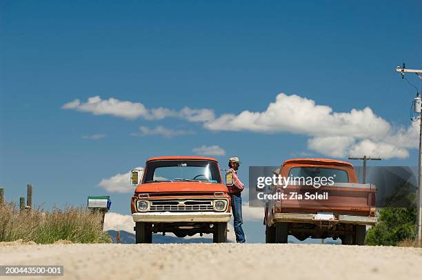 two pick-up trucks stopping on dirt road, people talking - two cars side by side stock pictures, royalty-free photos & images