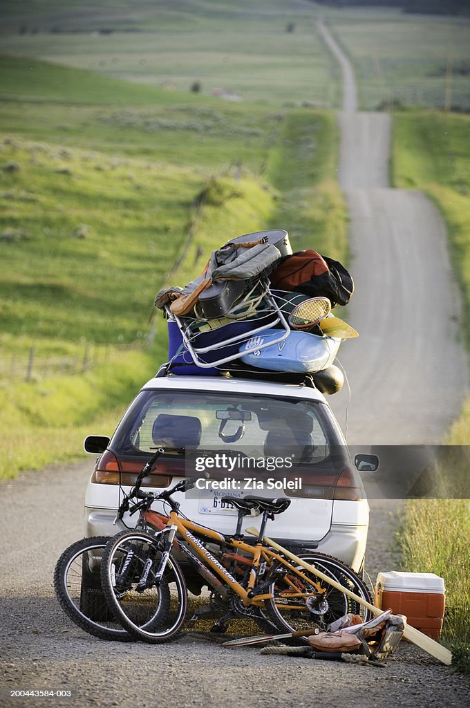 Car loaded with vacation gear on empty road