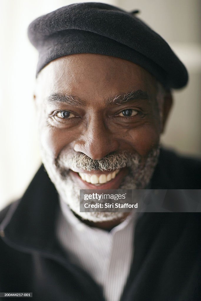 Mature man wearing beret, smiling