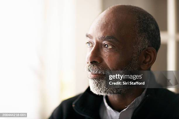 mature man standing in front of open door - 55 59 años fotografías e imágenes de stock