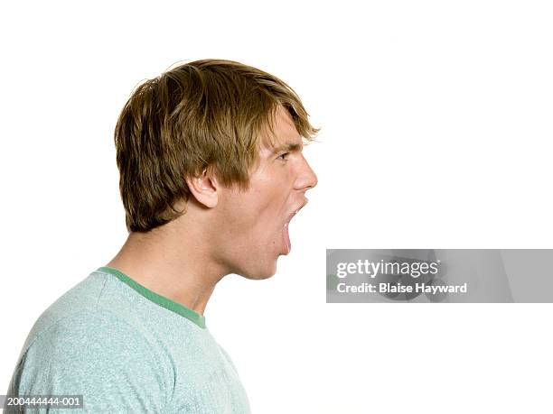 young man yelling - bocca aperta foto e immagini stock