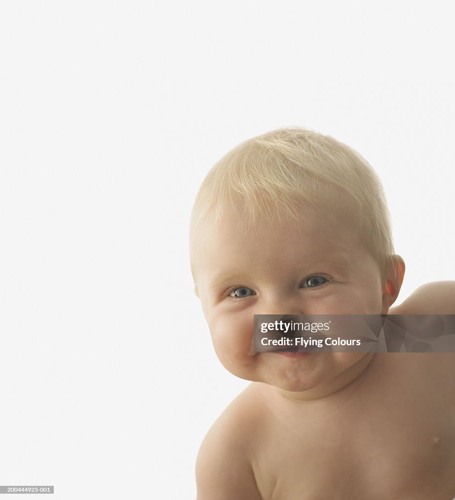 Baby boy (6-9 months) smiling, close up, portrait