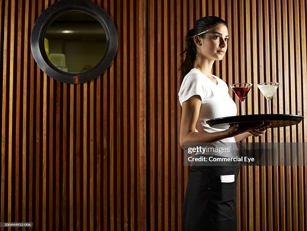 Waitress carrying tray with drinks