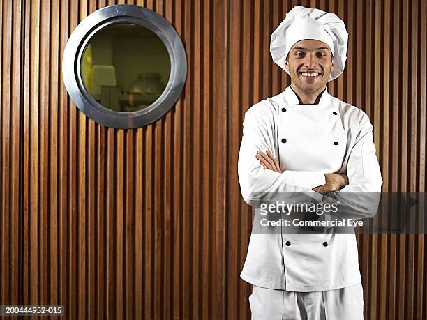 chef in front of entrance to kitchen, portrait - chef man ストックフォトと画像