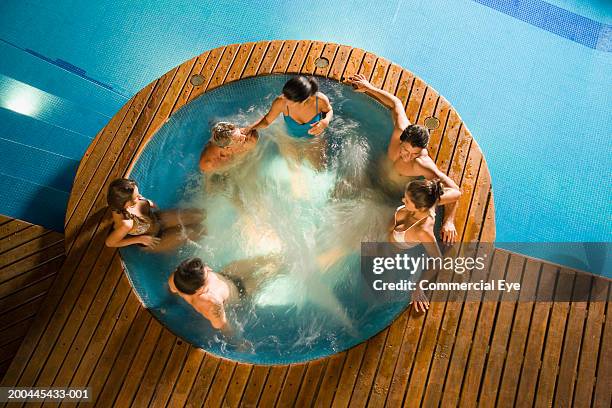 couples enjoying hot tub, elevated view - bain à remous photos et images de collection