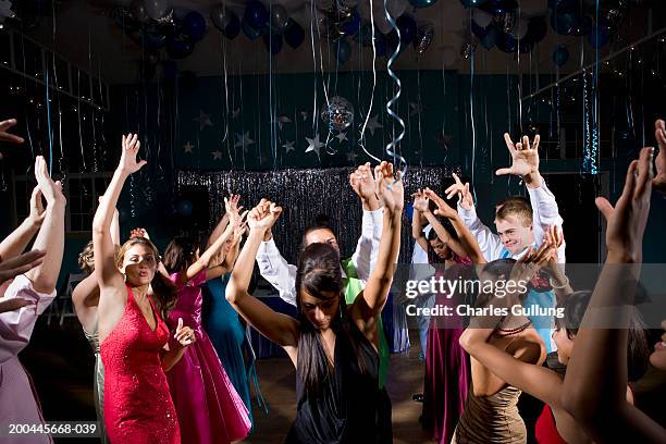 teenagers (15-18) in formalwear dancing at prom, arms raised - baile de finalistas imagens e fotografias de stock
