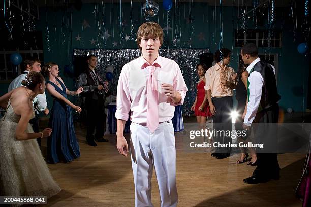 teenagers (15-18) dancing at prom (focus on boy in foreground) - prom stock pictures, royalty-free photos & images