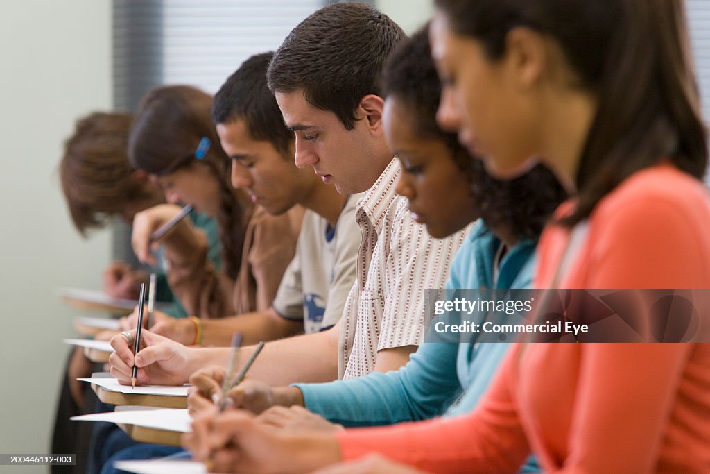 Students taking written examination, side view