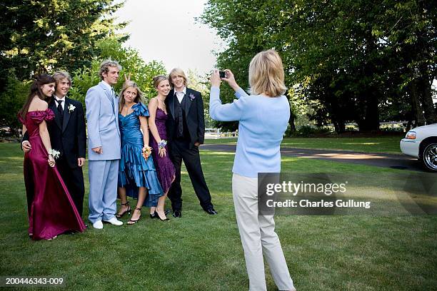 mother photographing three teenage couples (15-18) in formalwear - skolbal bildbanksfoton och bilder