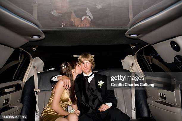 teenage boy and girl (14-16) in formalwear riding in limousine - prom limousine stock pictures, royalty-free photos & images