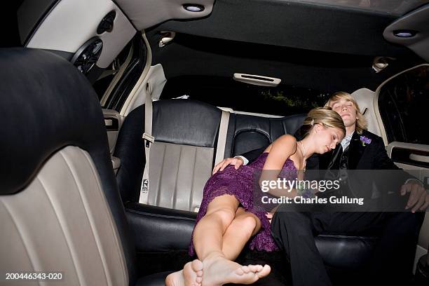 teenage boy and girl (15-17) in formalwear sleeping in limousine - prom limousine stock pictures, royalty-free photos & images