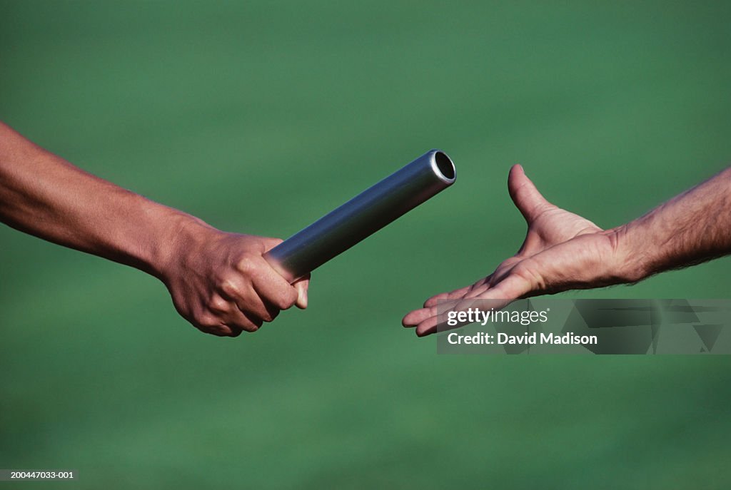 Baton change during relay race, close-up