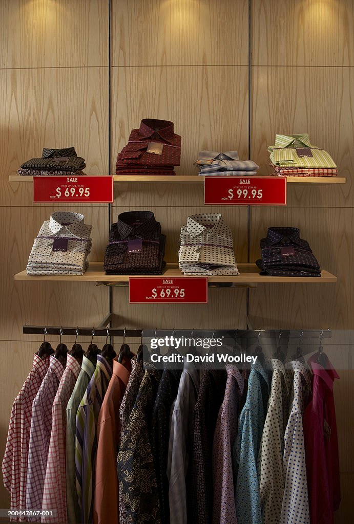 Mens' shirts on store display, labelled with sale signs