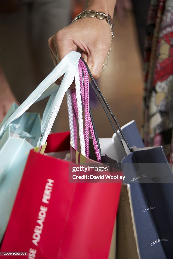 Woman holding shopping bags, close-up