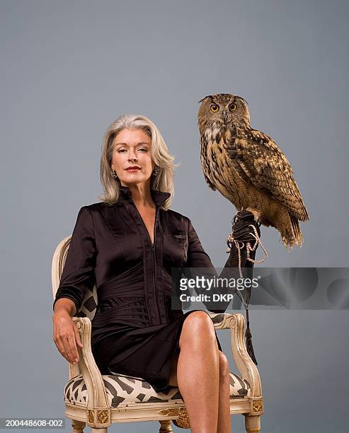 woman holding eurasian eagle owl (bubo bubo), sitting, portrait - bird portraits stock pictures, royalty-free photos & images