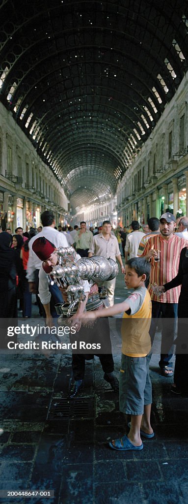 Syria, Damascus, Souq Al-Hamidyya, man selling tamarind juice