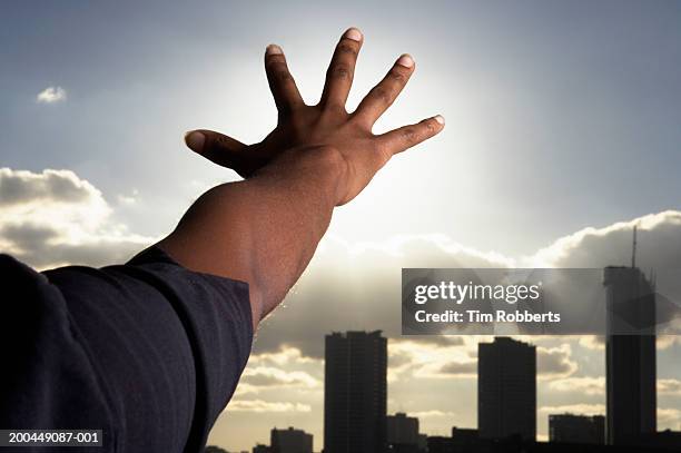 woman stretching arm towards skyline, close-up, rear view, sunset - woman arms outstretched stock pictures, royalty-free photos & images