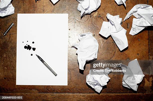 crumpled papers and ink splotches on paper, overhead view - vulpen stockfoto's en -beelden