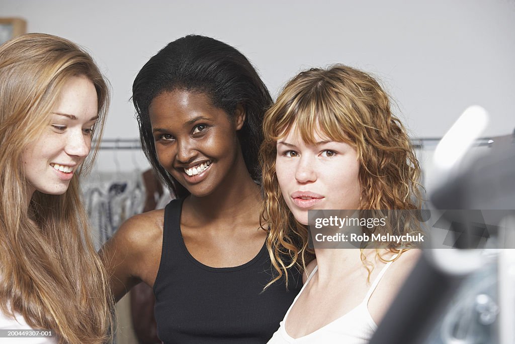 Three female models backstage at fashion show