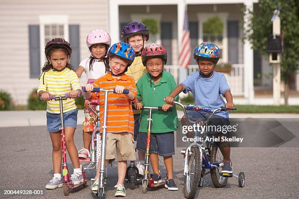 children (4-8) on scooters, portrait - bermuda shorts stock pictures, royalty-free photos & images