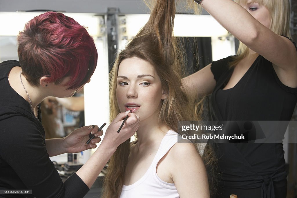 Teenage model (16-18) being styled backstage before fashion show